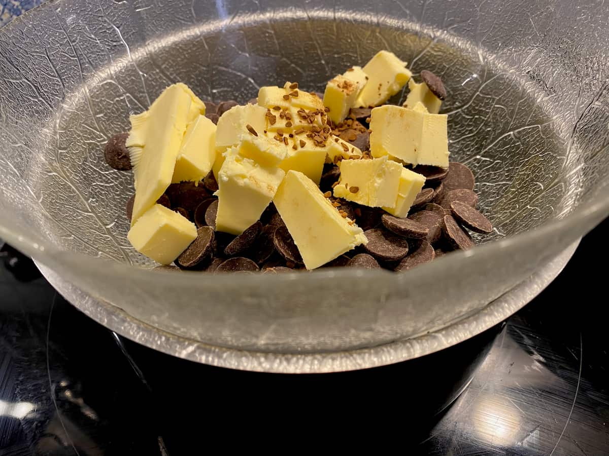 chocolate pieces, butter and coffee granules in a glass bowl over a pan of simmering water