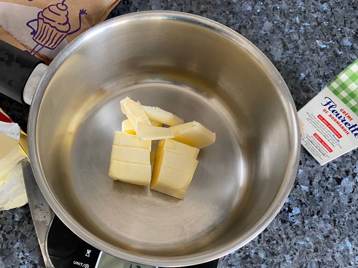 butter in a saucepan next to sugar and cream