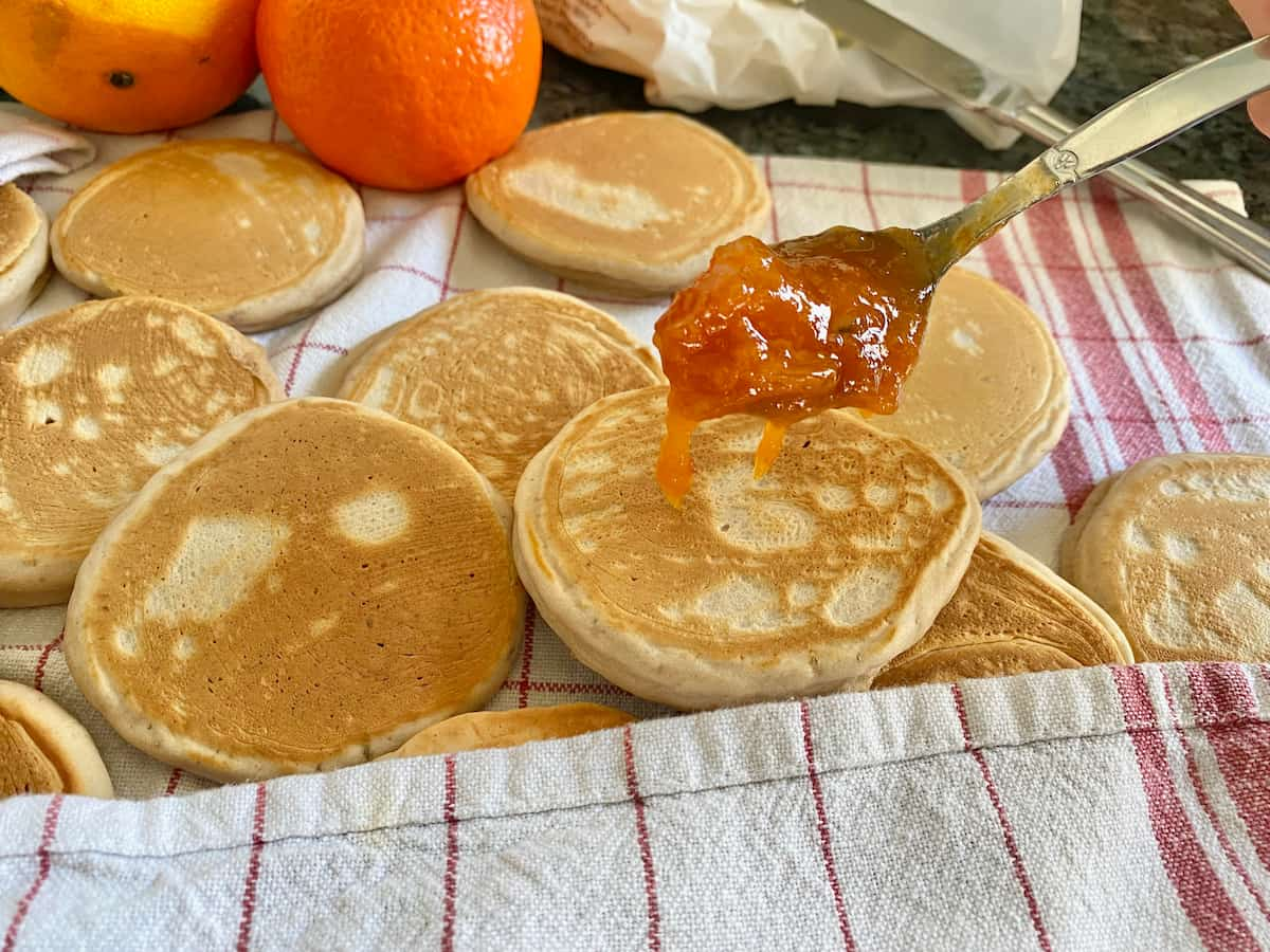 small thick pancakes with a spoonful of jam