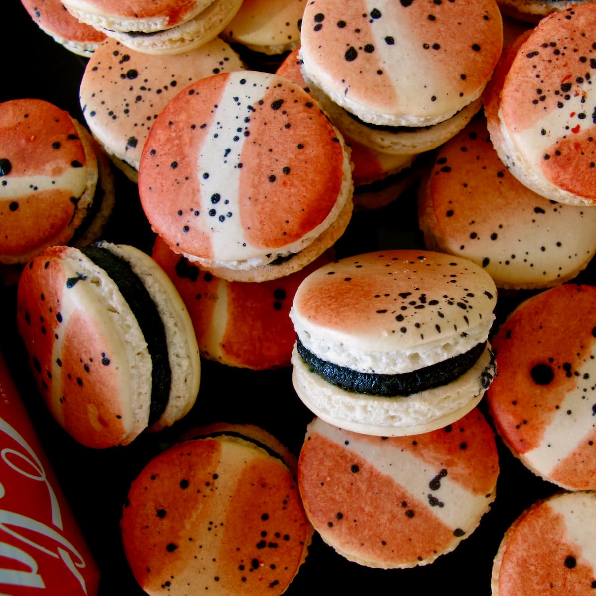 red and white striped coca cola macarons in a pile