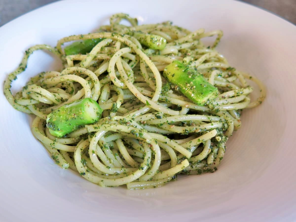 nettle pesto tossed into spaghetti with green asparagus