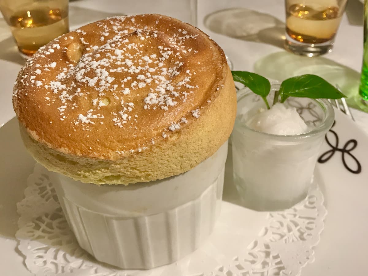 souffle dessert with small pot of sorbet