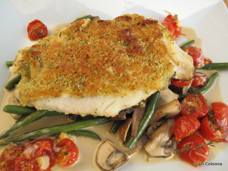 john dory fish with grilled herb crust surrounded by vegetables and sauce