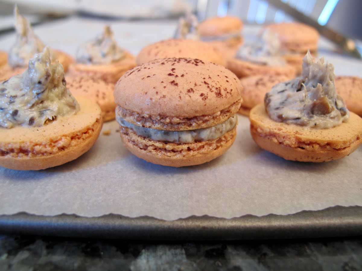 filling macaron shells on baking sheet