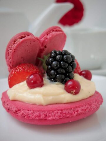 giant macaron open like an oyster shell with berries
