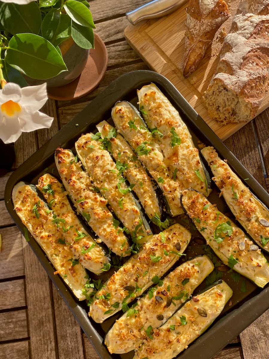 baked zucchini boats filled with cheese, herbs, nuts and seeds