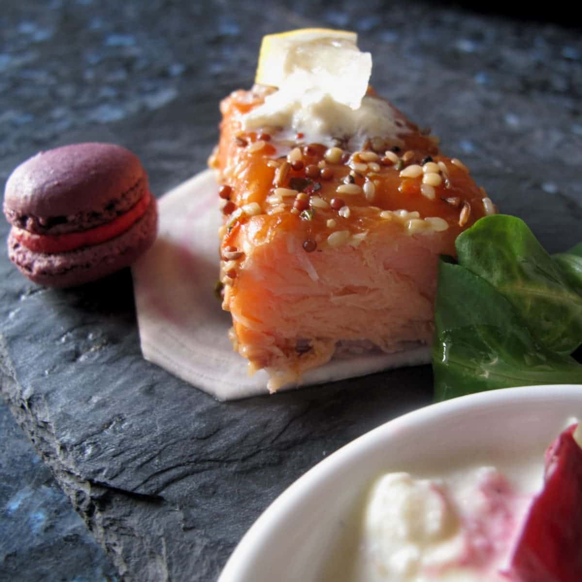 Beet-horseradish-macarons-with apple-salmon bowl of creamy sauce next to smoked salmon