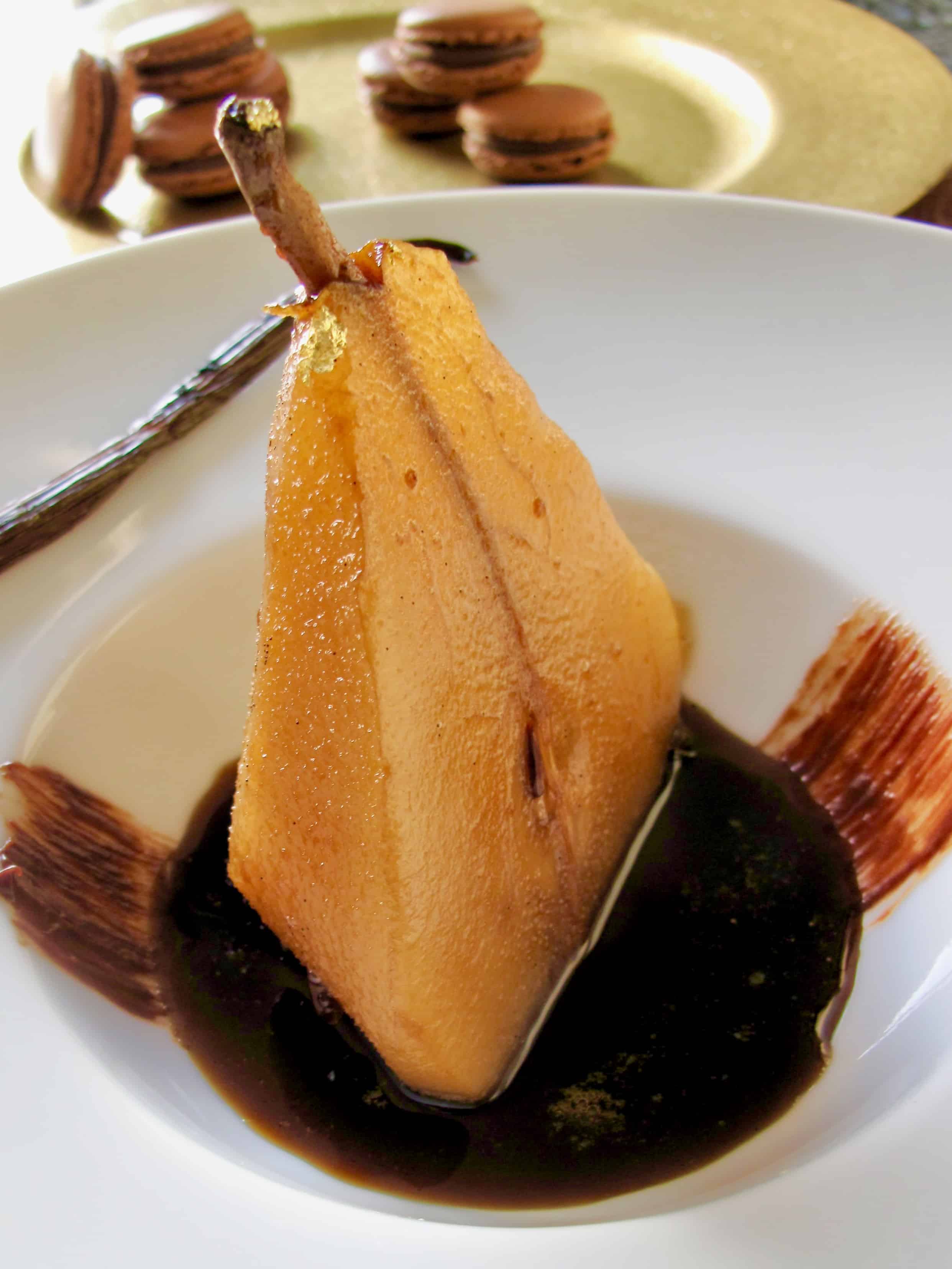 half a poached pear sitting in a puddle of vanilla and coffee syrup