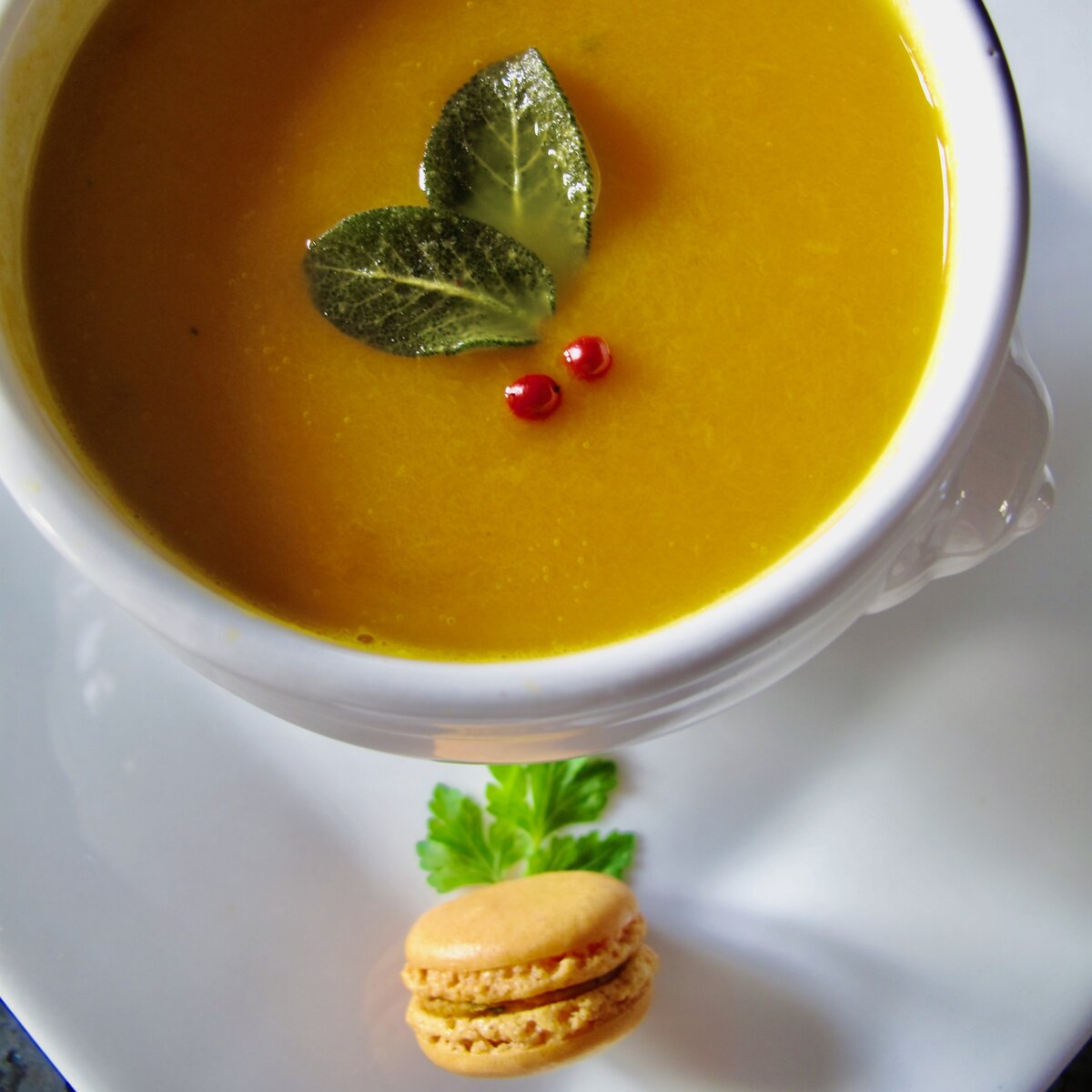 pumpkin leek soup with macaron and festive decoration