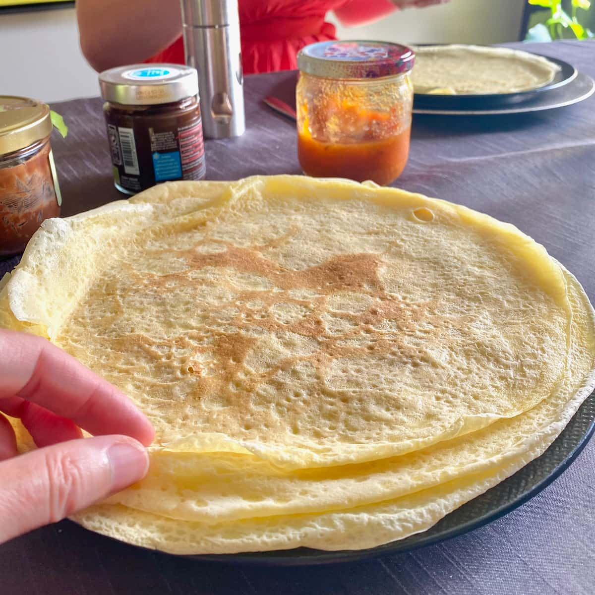 thin crepe pancakes stacked on a plate