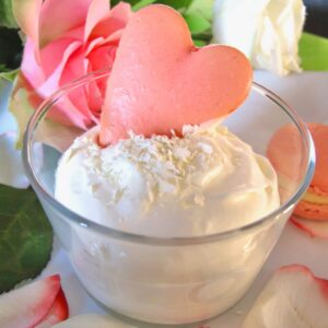 white chocolate mousse in a bowl with rose petals and love heart macaron