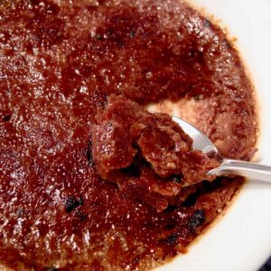 cracking a spoon into a chocolate creme brulee