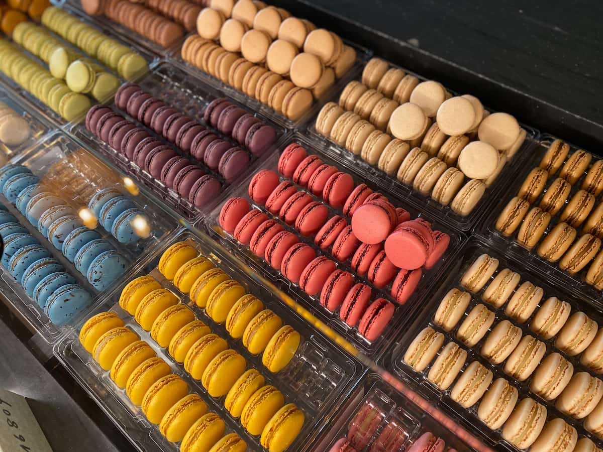 rows of colourful macarons in a store in Paris