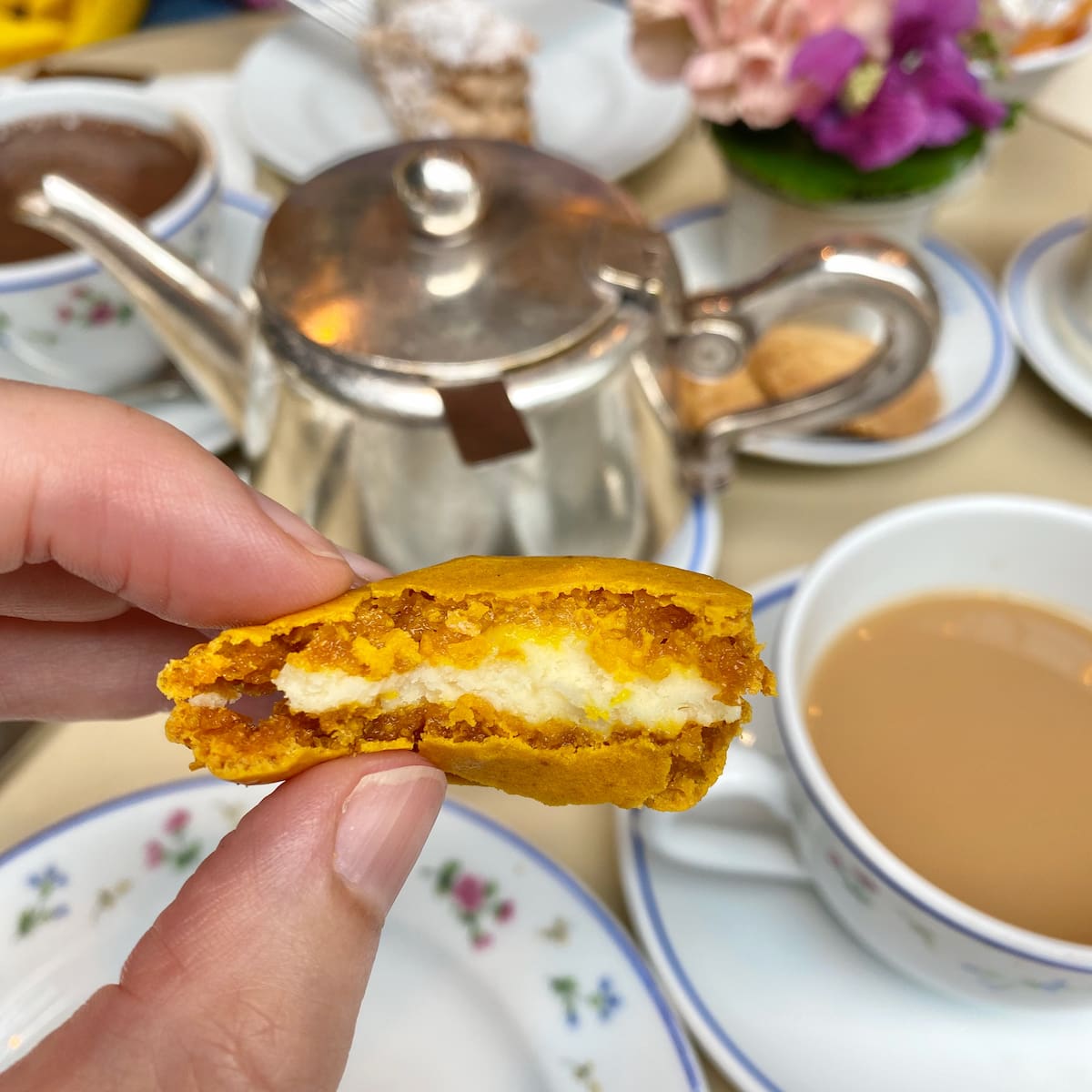 biting into a lemon macaron at afternoon tea