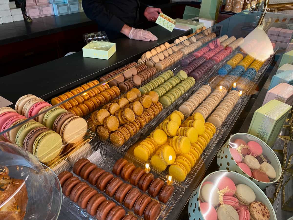 rows of colourful macarons in a patisserie