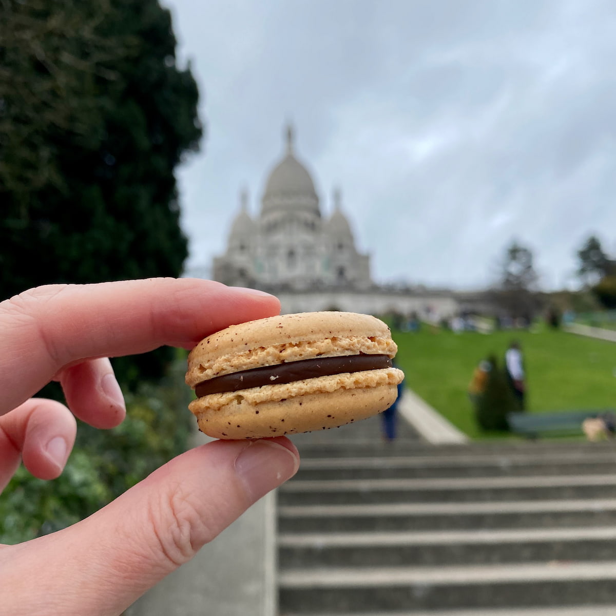 perfect macaron with frilly foot in front of Montmartre steps