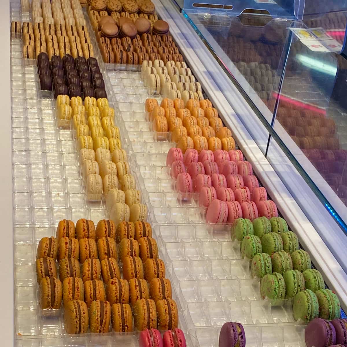 rows of colourful macarons in window