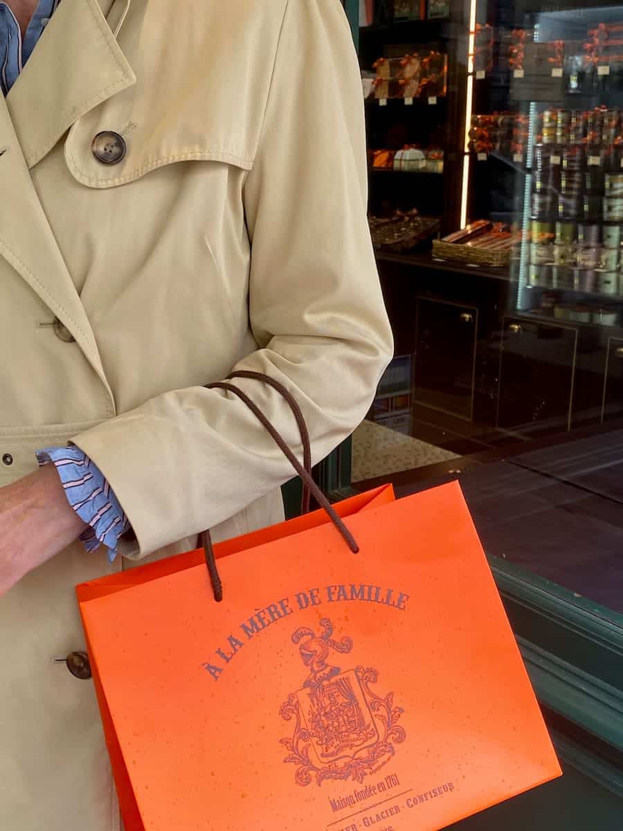 raincoat with orange Parisian patisserie bag