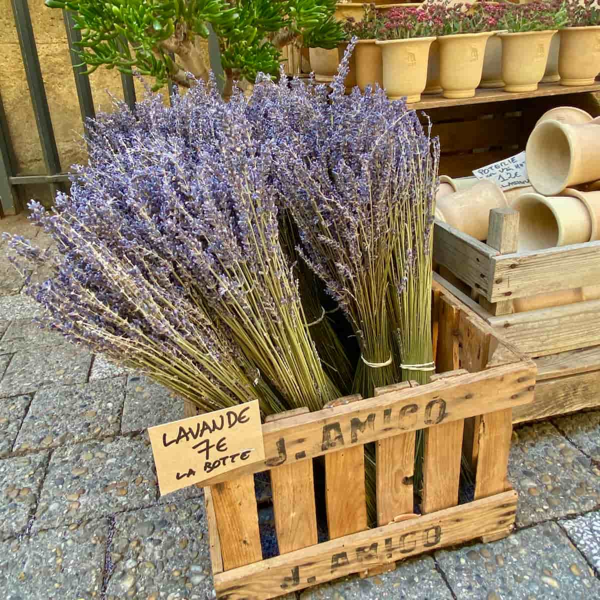 wooden crate of bunches of dried purple lavender flowers