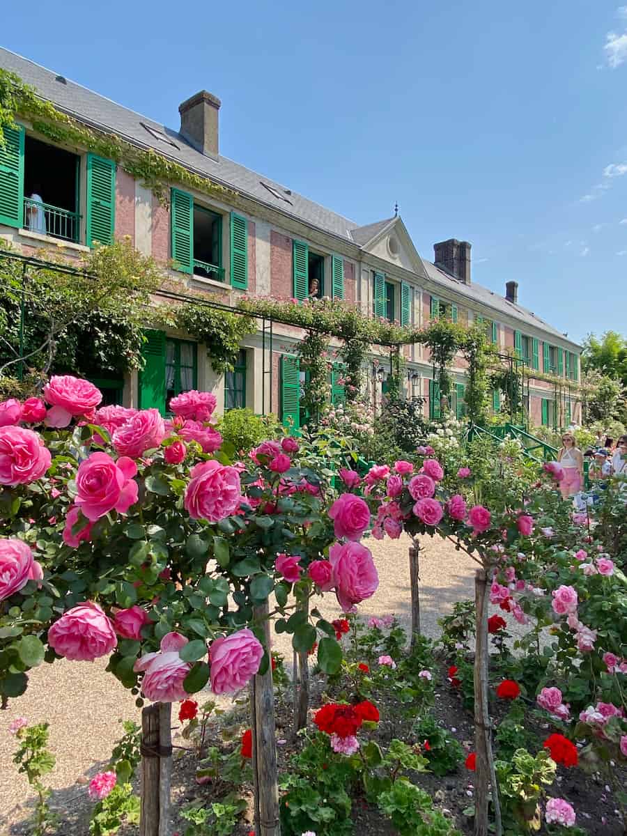 Japanese-bridge-Monet-Giverny pink roses in front of Monet's house in Giverny