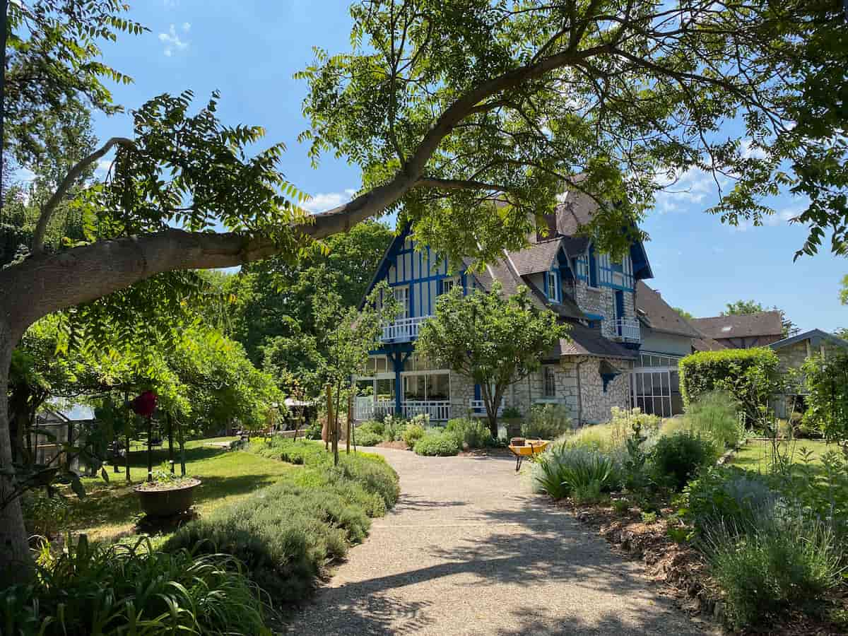 timbered Normandy style French restaurant and hotel in gardens