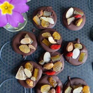 chocolate disks topped with dried fruits and nuts