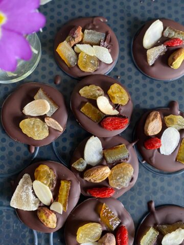 chocolate disks topped with dried fruits and nuts