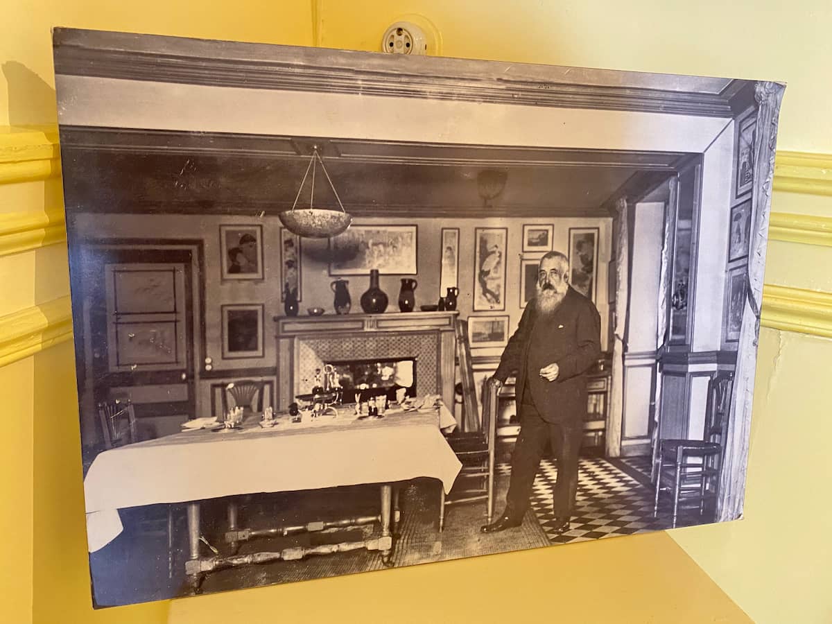 French impressionist painter, Claude Monet standing in his dining room in Giverny