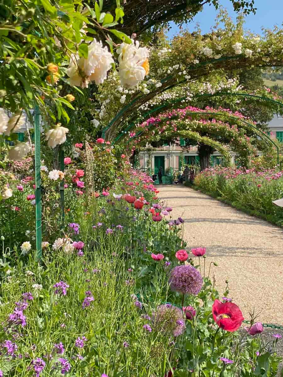 Monet-gardens-France roses and poppies up to Monet's house entrance in Giverny