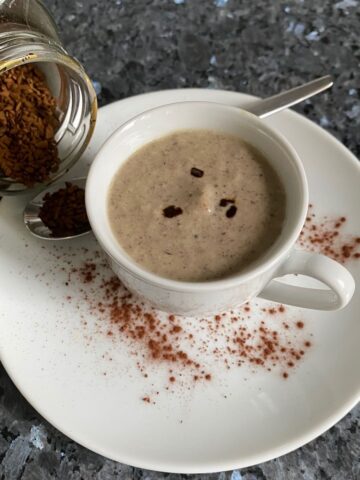 cup and saucer of creamy French mushroom soup with coffee