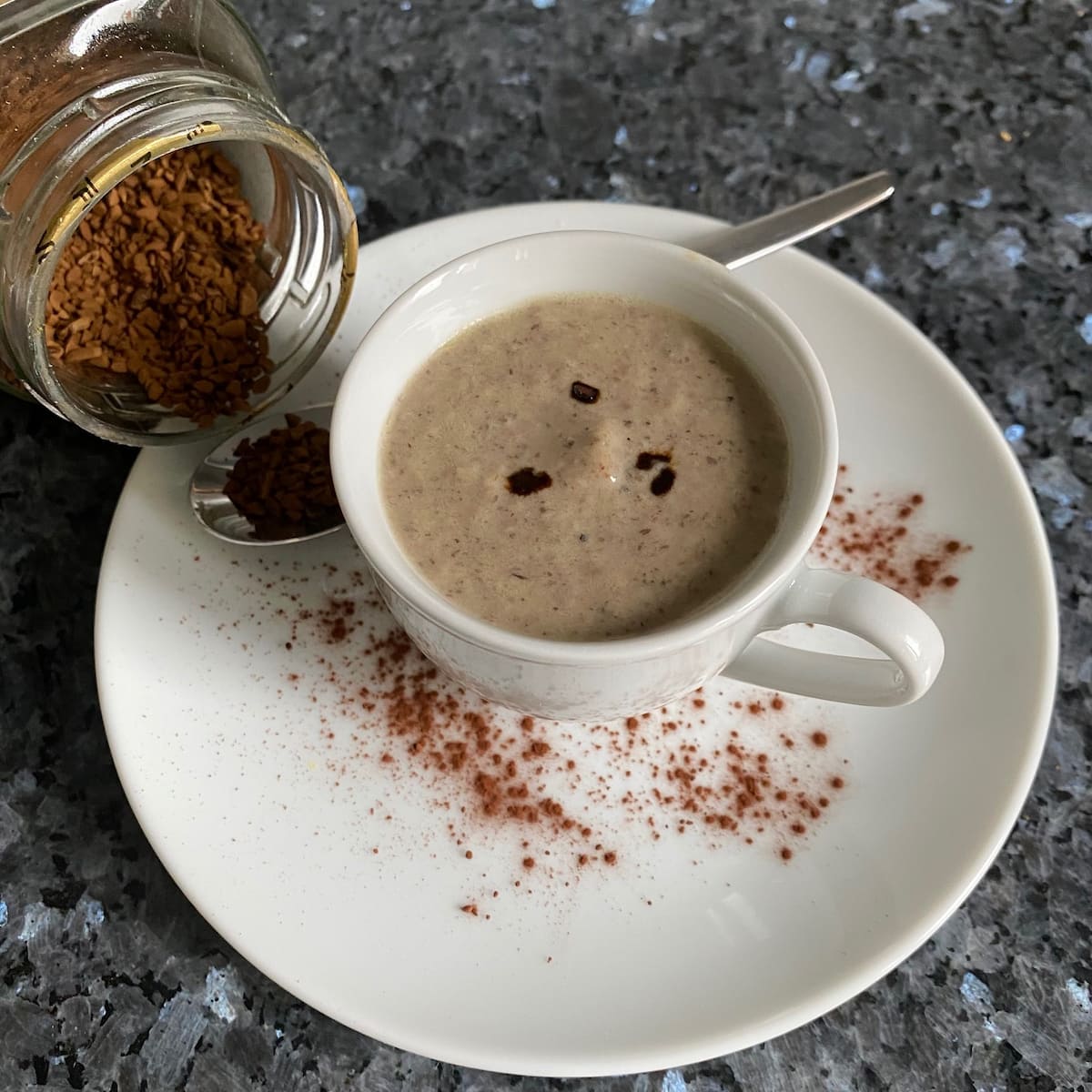 cup and saucer of creamy French mushroom soup with coffee