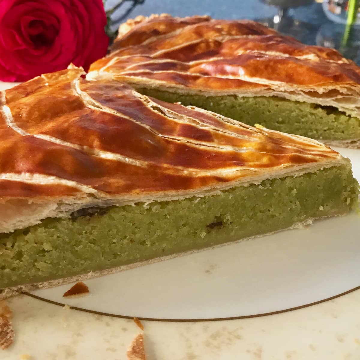 slice of galette des rois filled with pistachio and chocolate 