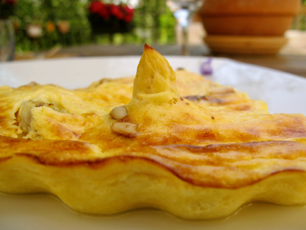 slice of savoury clafoutis baked custard made with white asparagus