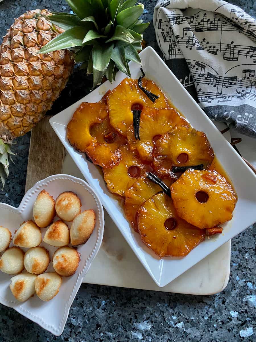 roasted caramelised pineapple slices served next to little mounds of coconut cookies