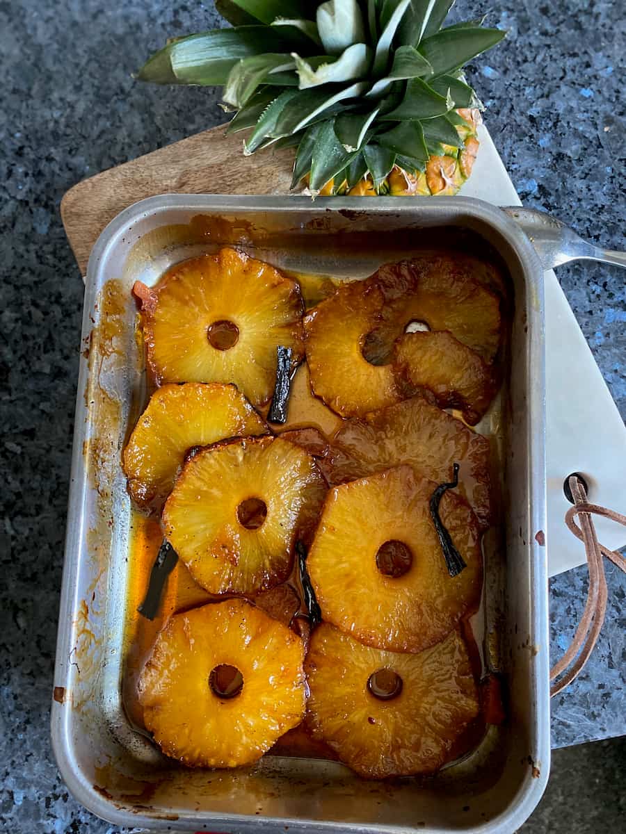 roasting tin with pineapple slices baked in caramel
