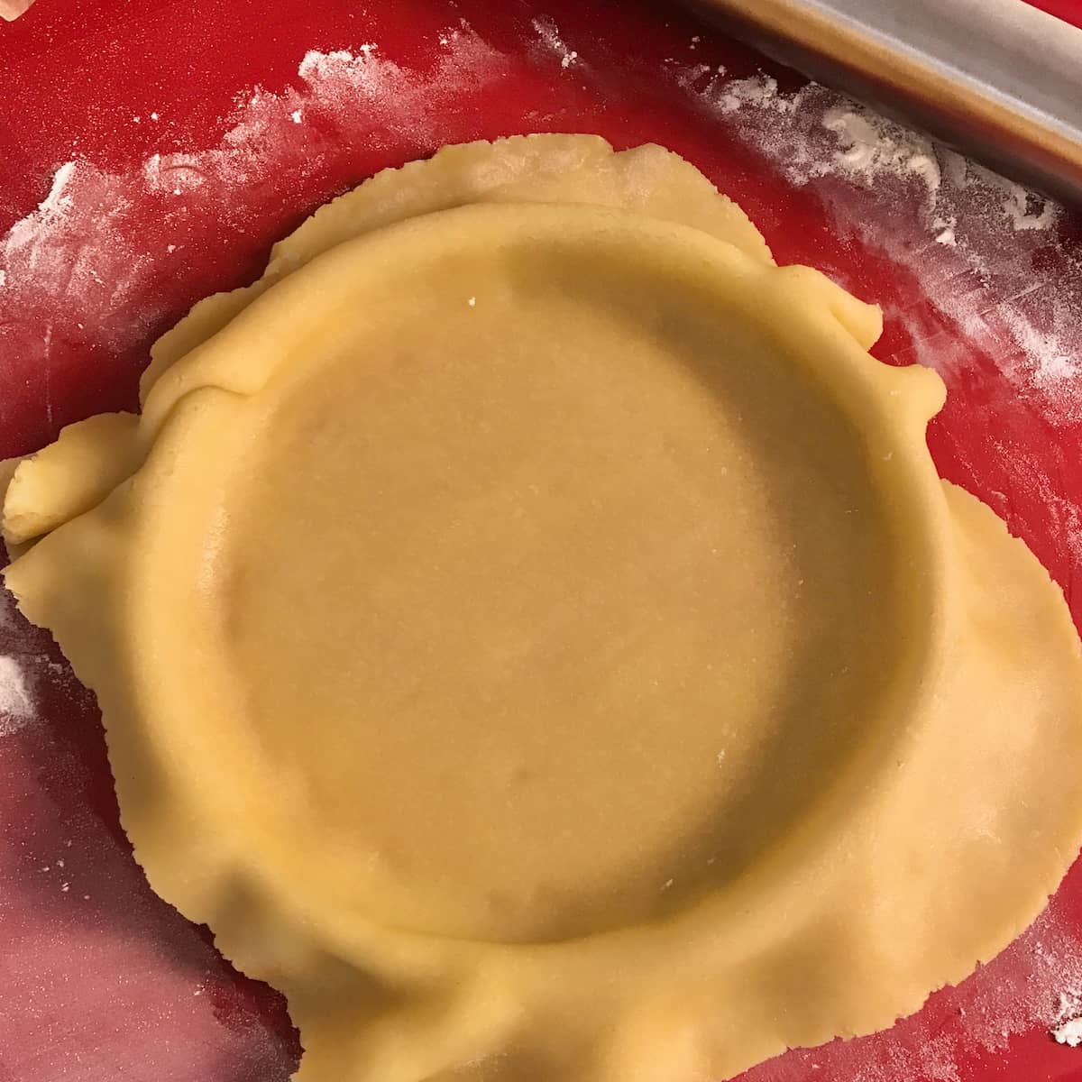 tart dough placed on top of a pastry tart ring