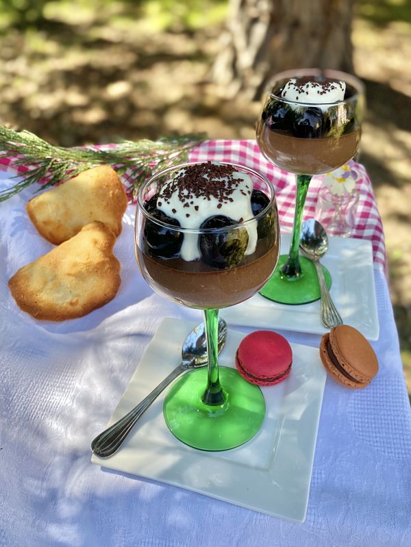 German chocolate cream desserts in wine glasses served with tuiles and macarons