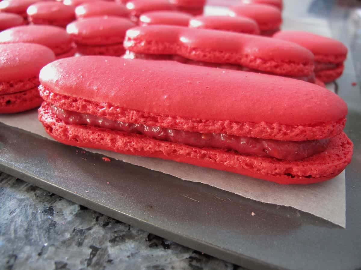 macalongs or long shaped macarons with a raspberry filling made with white chocolate ganache