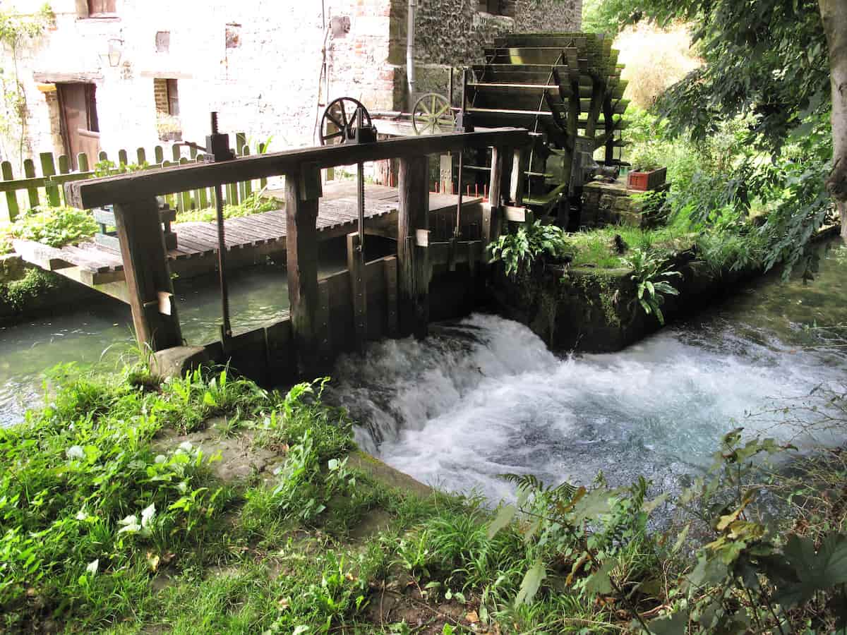 Smallest river in France, Veules-les-Roses, Normandy watermill wheel churning in a river