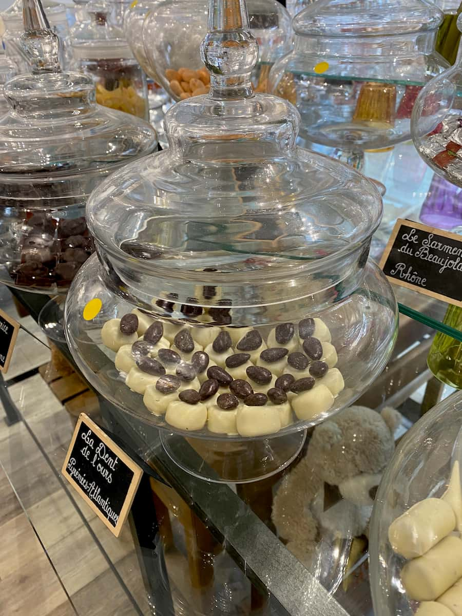 glass jar containing handmade sweets with white chocolate topped with a dark chocolate