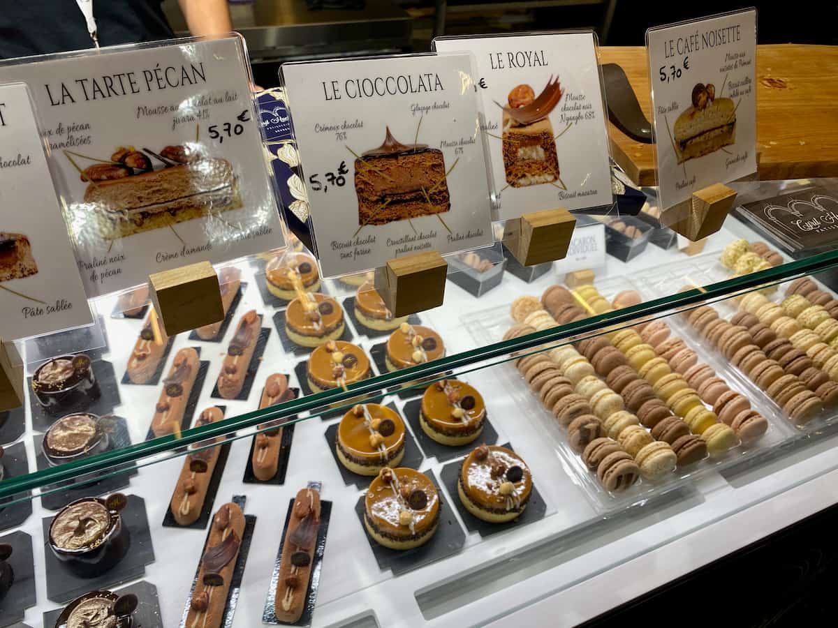 glass case presenting beautiful French macarons and cakes