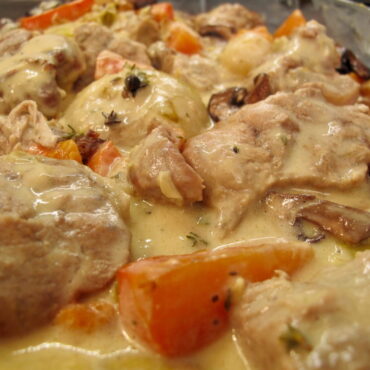 veal stew with white sauce in carrots, mushrooms and onions