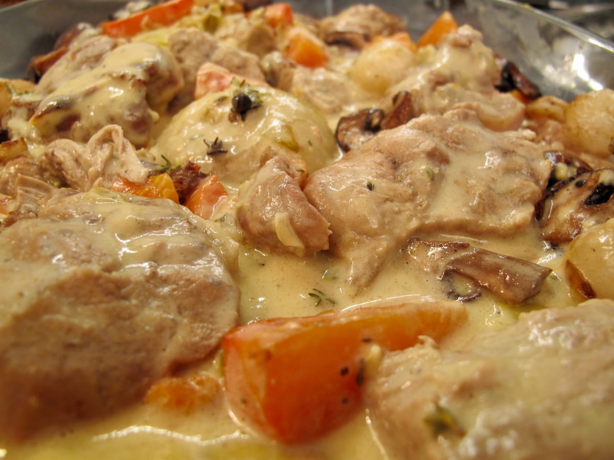 veal stew with white sauce in carrots, mushrooms and onions