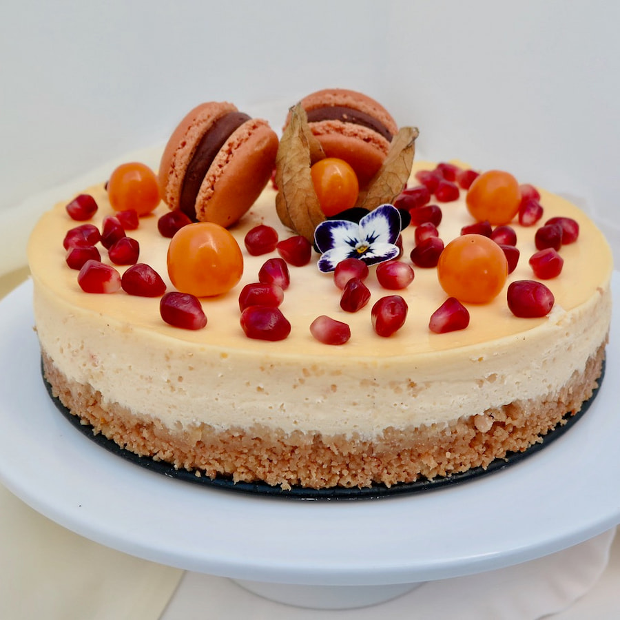 cheesecake topped with macarons and fruit