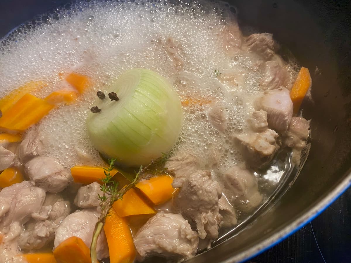 blanquette recipe method - a French veal stew bubbling in pot