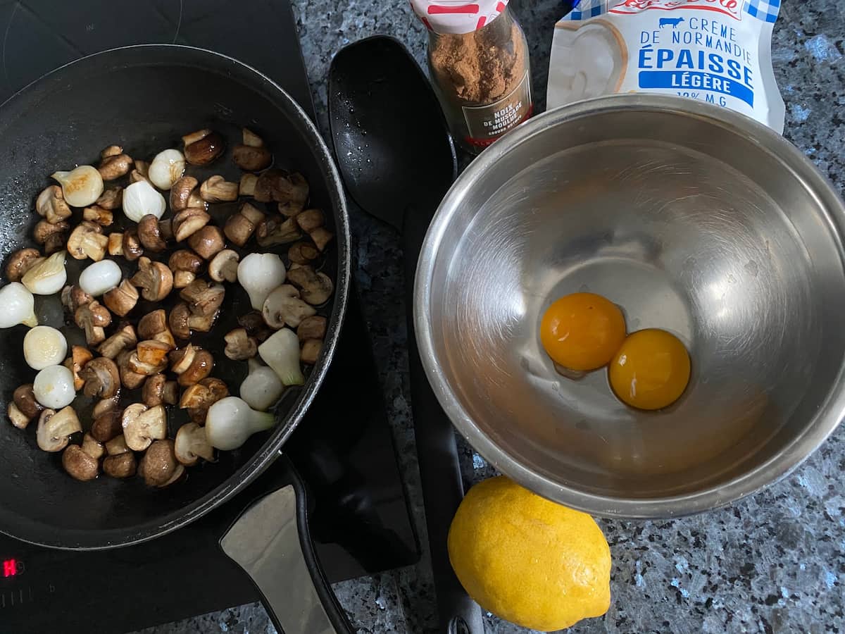 Ingredients for blanquette de veau French casserole recipe frying mushrooms onions and preparing a sauce with lemon and yolks for a blanquette de veau