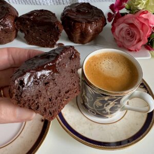 glazed chocolate coffee cakes, extra fudgy served with a cup of coffee