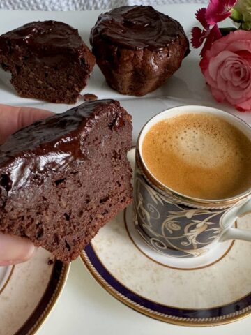 glazed chocolate coffee cakes, extra fudgy served with a cup of coffee