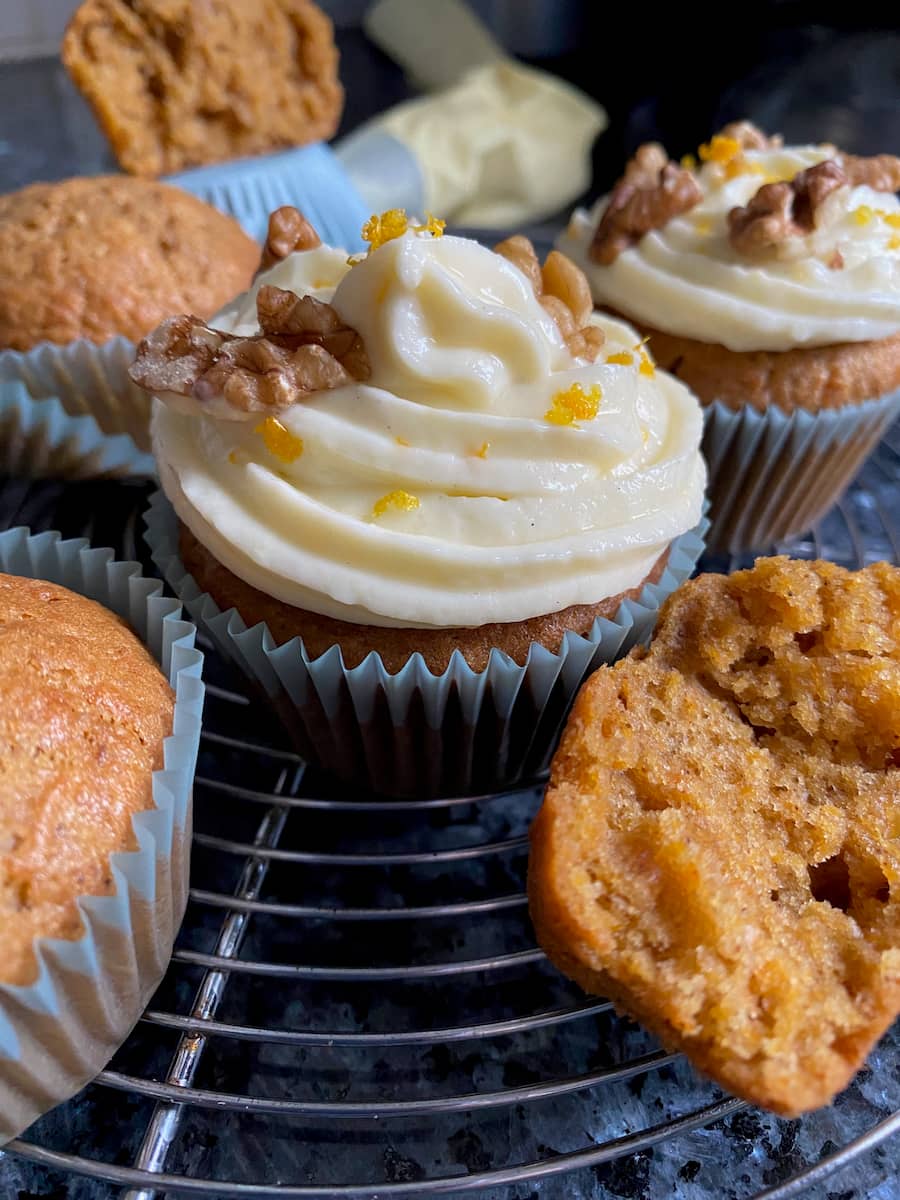 cream cheese frosting with orange zest and walnuts on muffins