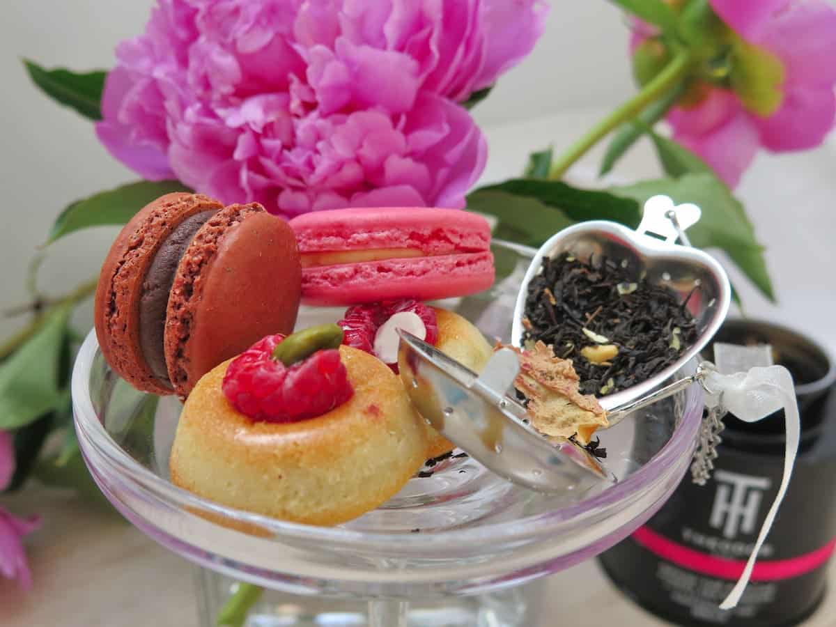 Little teacakes and macarons with tea and peony roses